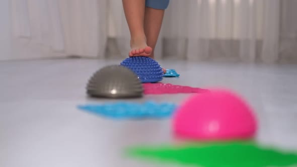 Legs of a Small Child on Orthopedic Mats