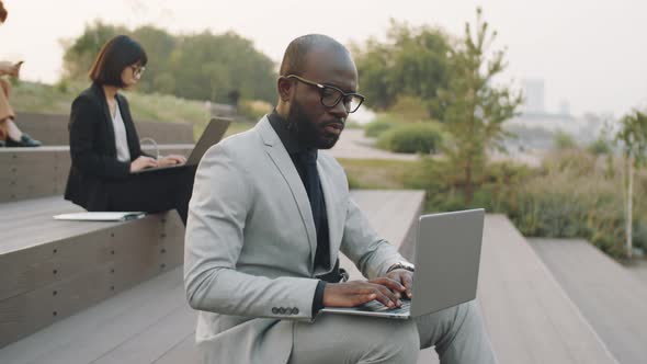 African American Businessman Working on Laptop in Park