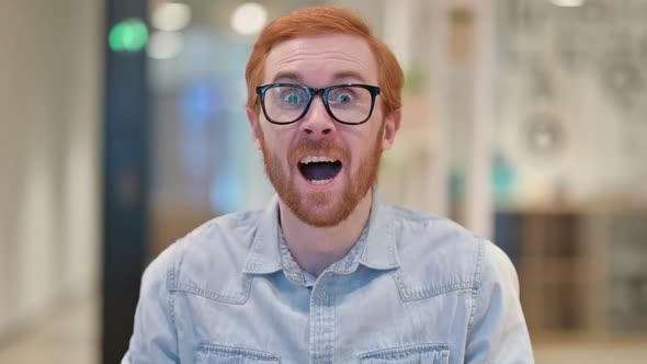 Excited Young Redhead Man Celebrating Success