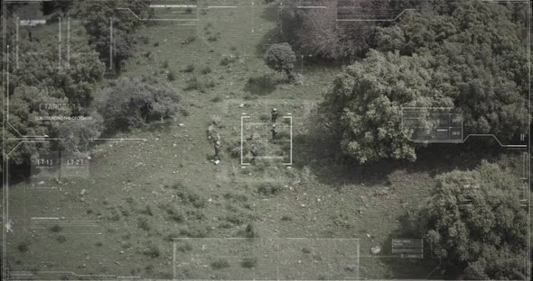 Surveillance drone view of soldiers walking through a forest with hud graphics