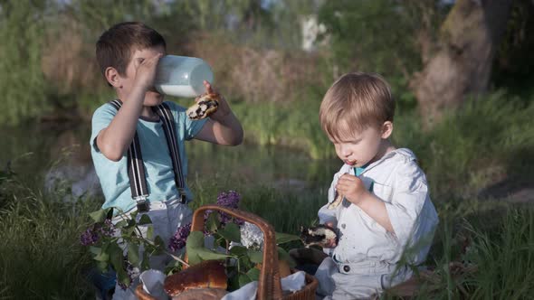 Snack, Hungry Kids Have Fun Eat Baking and Drink Milk From a Glass Jar