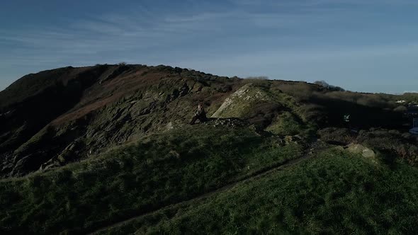 Aerial of young woman looking out over the ocean