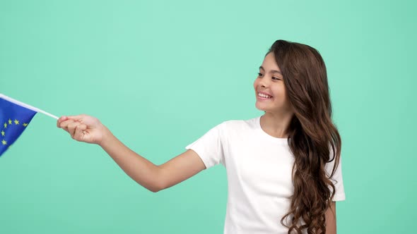 Kid with Happy Face Waving European Union Blue Flag Showing Thumb Up Gesture Vacation Abroad