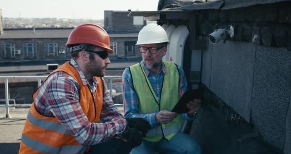 Engineer and Technician Discussing About Security Camera