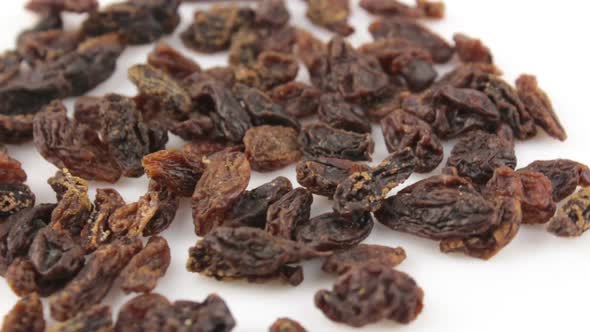 Close-up a Handful of Sweet Raisins Rotate on a White background.Sweet Organic Raisins Rotate on a