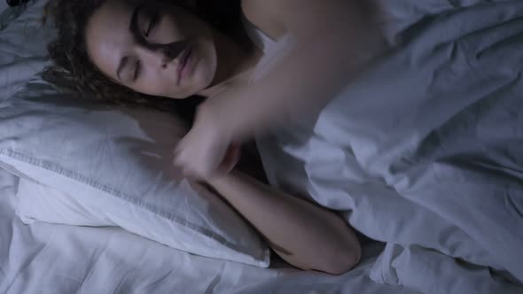 Tired Female Falling Asleep in Bed at Night, Dark Room