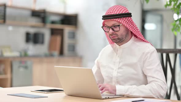 Young Arab Businessman with Laptop Saying No with Finger Sign