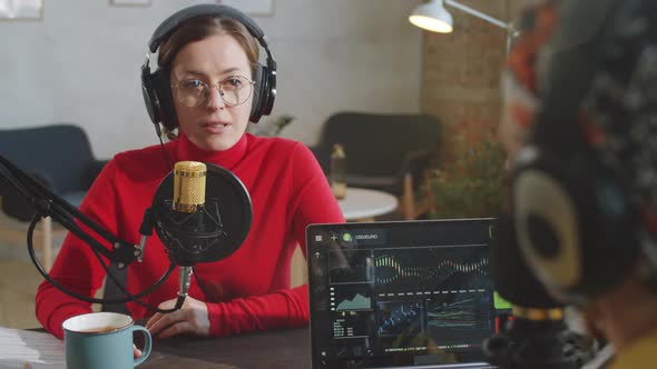 Woman Giving Interview to Podcast Presenter in Studio