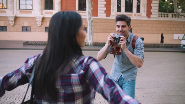 Young Mixed Race Tourist Couple Taking Pictures on Vintage Camera While Walking Through the City