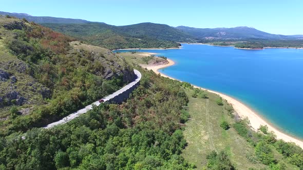 Aerial view of paved road passing artificial lake of Peruca, Croatia