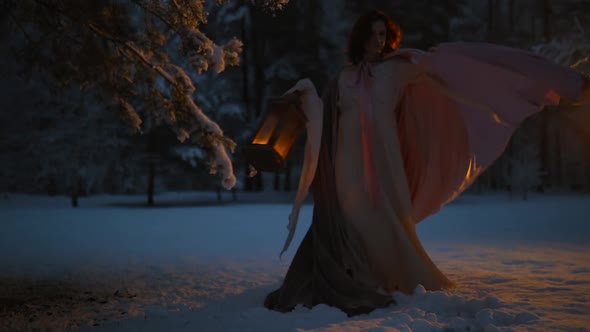 Young Woman Dancing with Her Spinning Cloak Holding Vintage Lantern