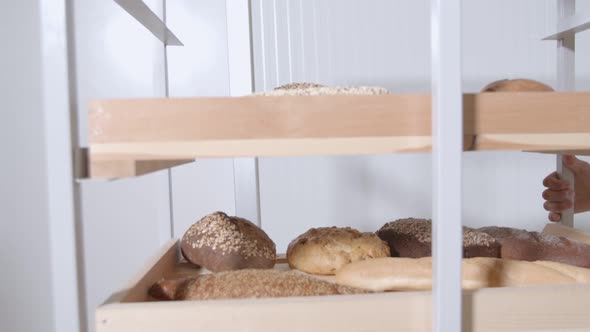 Fresh Baked Long Baguette Breads Lie on the Wooden Table Sprinkled with Flour in a Pile