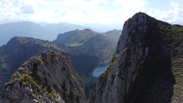 Flying with the drone inbetween two rocks to a beautiful swiss mountain lake (Oberstockensee)