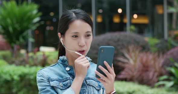 Woman chat on the earphone at outdoor