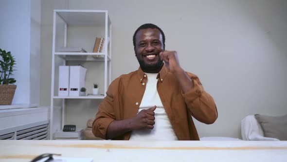 African Man Dancing at Desk in Office During Break Spbas