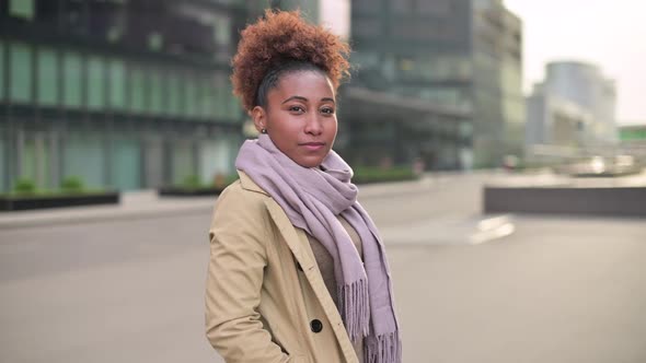 Young attractive black woman posing on the background of a city street