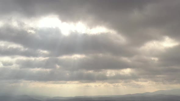 Rays of sun through the cloudy sky 4K drone footage
