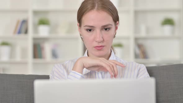 Portrait of Pensive Young Woman Working on Laptop 