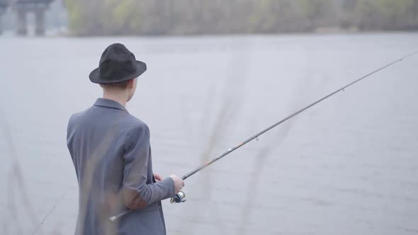 Fisherman in a Jacket and a Cap with a Brim Young Fisherman in a Jacket and a Cap with a Brim