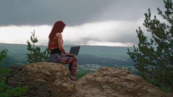 Girl Freelancer Works at Laptop on Mountain Landscape