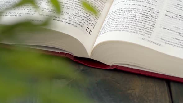 Close Up of Leafing Book Pages on Gray Wooden Table