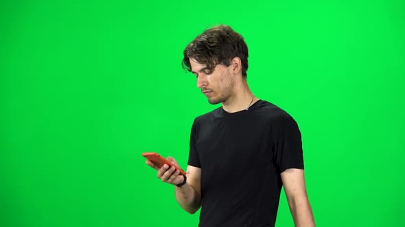 Brunette Guy Goes and Texting on the Phone, Chroma Key. Slow Motion