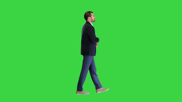 Young Handsome Business Man Walking and Talking To Himself on a Green Screen Chroma Key