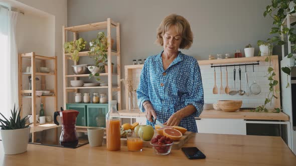 beautiful senior woman spending time in her cozy apartment