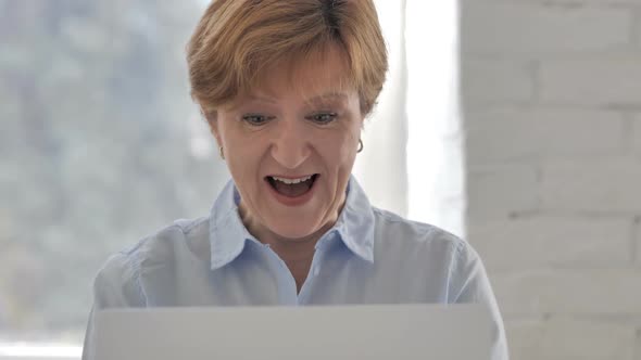 Excited Old Woman Celebrating Success Working on Laptop