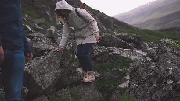 Young Couple with Leather Bags Hiking in Iceland Cinematic Shot