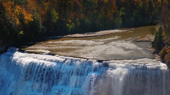 Waterfall at Genesee River with Banks Covered with Autumn Forest