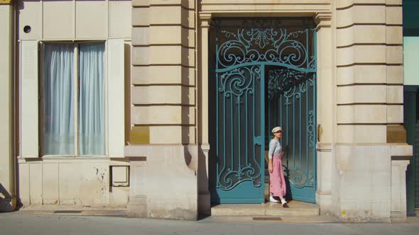 Attractive girl leaving a building, France