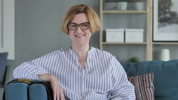 Smiling Old Woman Sitting on Couch