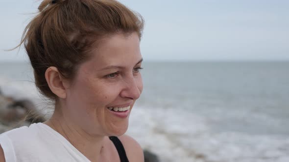 Woman relaxing on sandy beach  before sunset  4K 2160p 30fps UltraHD footage - Female enjoying  wave