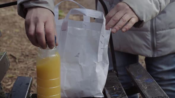 Unpacking healthy packed lunch on park bench medium shot