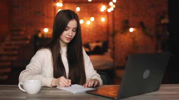 A Woman is Sitting in Her Home Office