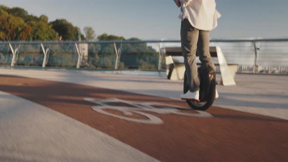 Pensioner Holds Phone Riding Electric Unicycle on Footbridge