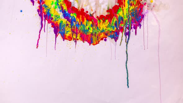 Various Colors Are Dripping On A White Background