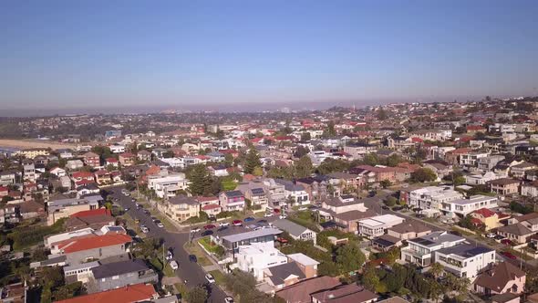 Aerial flying over beautiful beachfront properties blocks in the neighborhood.