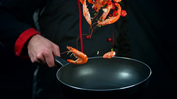 Super Slow Motion Shot of Chef Holding Frying Pan and Falling Shrimps at 1000Fps