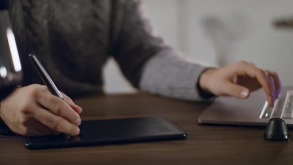 Closeup of an Artist's Hand on a Graphics Tablet