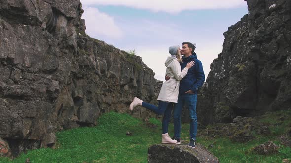 Young Loving Couple Tourists in Canyon of Iceland
