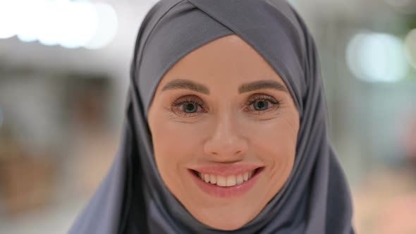 Close Up of Face of Young Woman Smiling at Camera