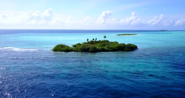 Luxury aerial tourism shot of a white sandy paradise beach and aqua blue ocean background in high re