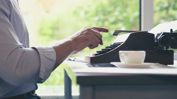 Young man typing on a typewriter