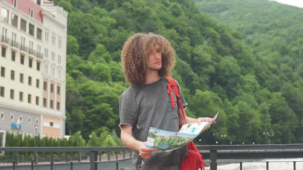 Tourist with Route Maps Looking for a Way in City. Search Landmarks