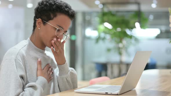 Casual African Woman with Laptop Coughing 