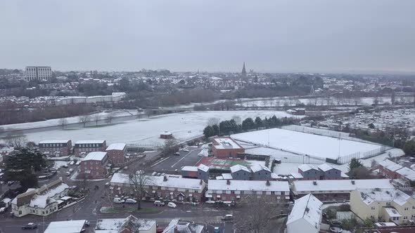 Push forward drone shot of a snowy Exeter looking towards the town centre over the River Exe CROP