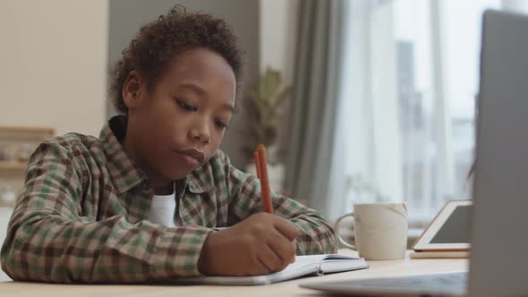 School Boy Doing Homework Alone