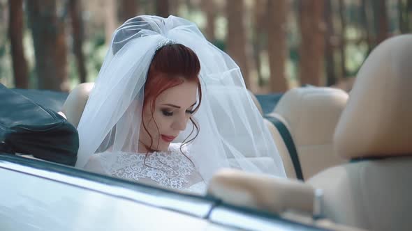 Tired of Photo Sessions the Bride Sits in a Cabriolet Closeup Slow Motion